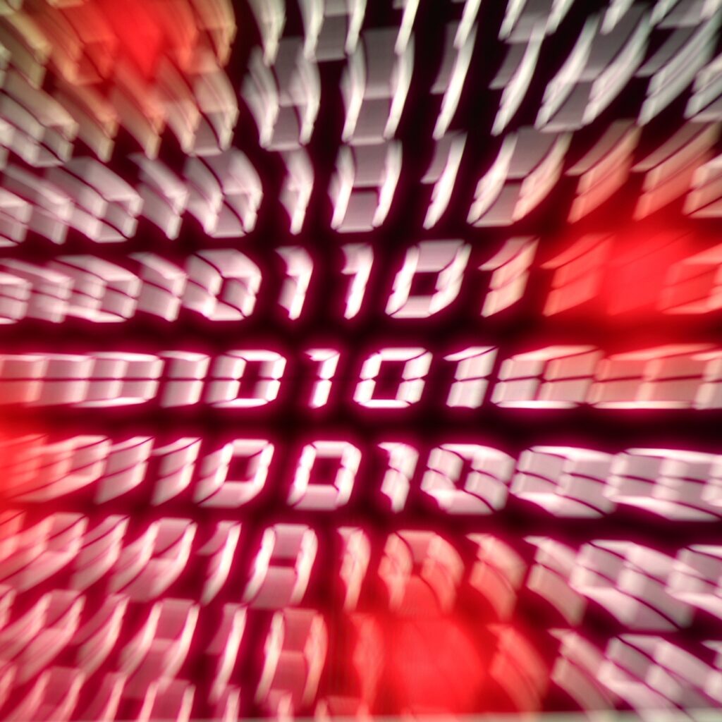 Binary number stream blurred with zoom effect representing information technology computers network