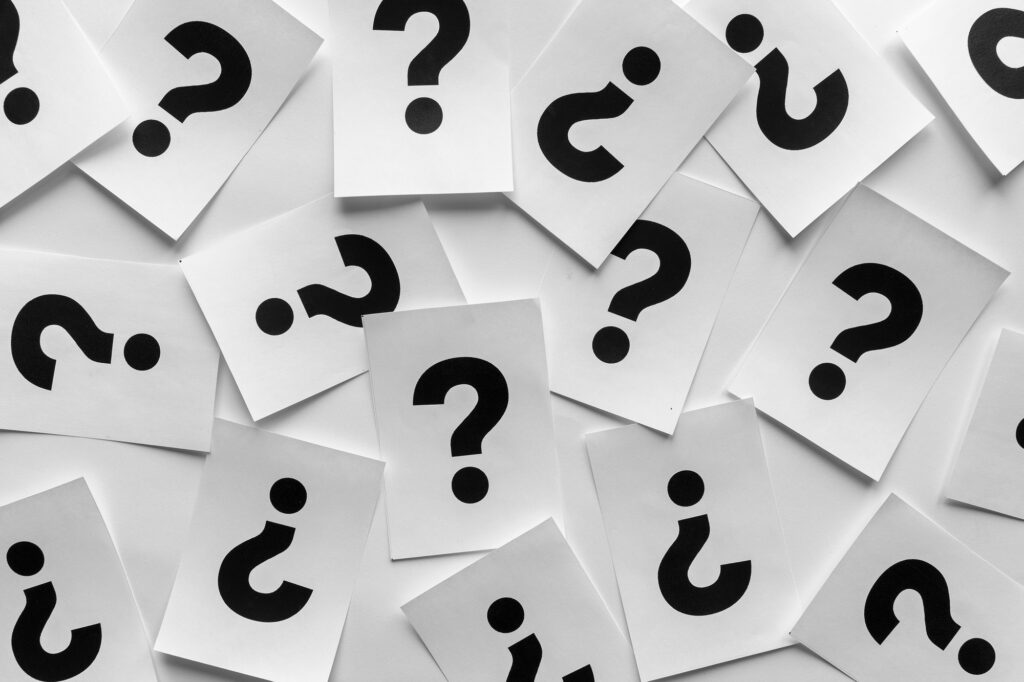Bold black question marks on paper cards