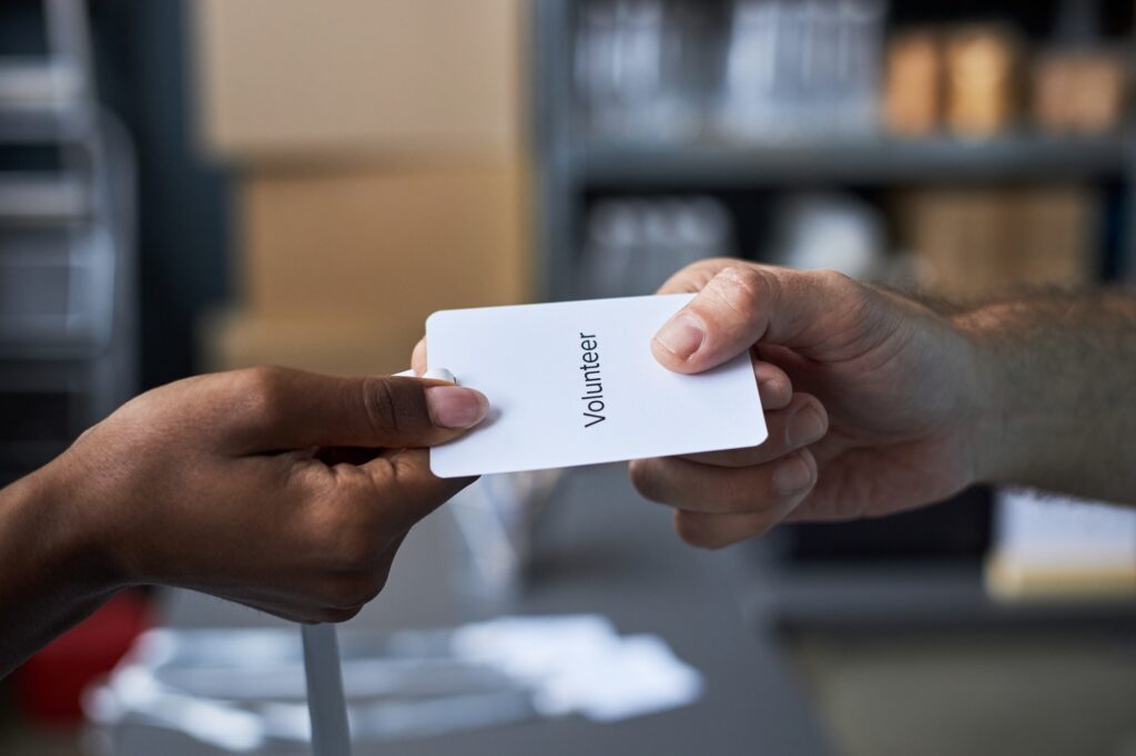 Handing Volunteer Badge in Office Setting